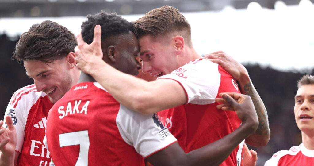 Arsenal players celebrate scoring in their Premier League game against Fulham