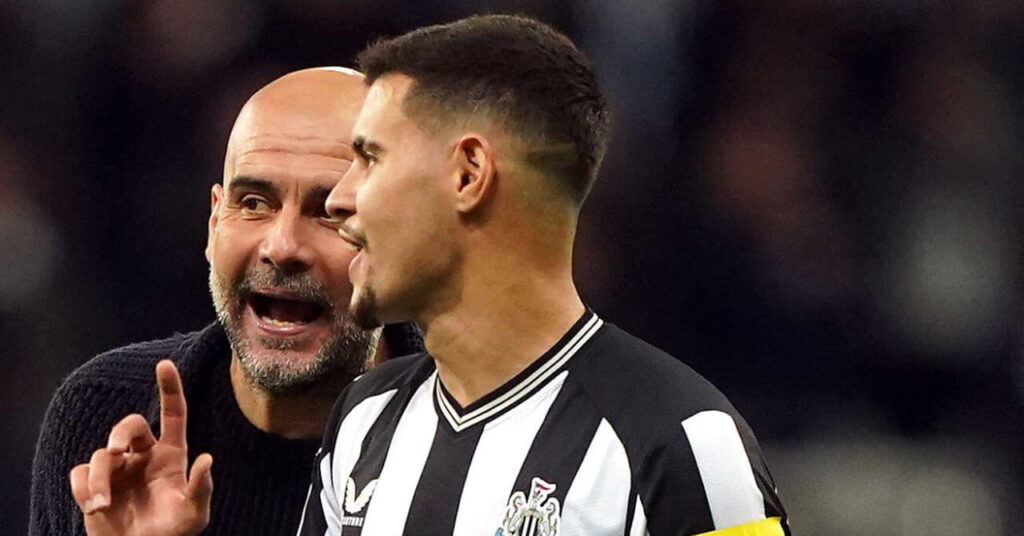 Brazil footballer Bruno Guimaraes talking to opposition football manager Pep Guardiola while playing for Premier League team Newcastle United Football Club and wearing a black top with white trim and the club badge on the chest