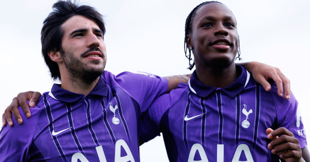 Footballers Sandro Tonali and Jun'ai Byfield embrace each other while wearing the purple third shirt of Premier League team Tottenham Hotspur Football Club