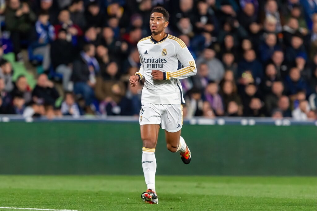 England footballer Jude Bellingham running in front of a crowd while playing for La Liga team Real Madrid Football Club