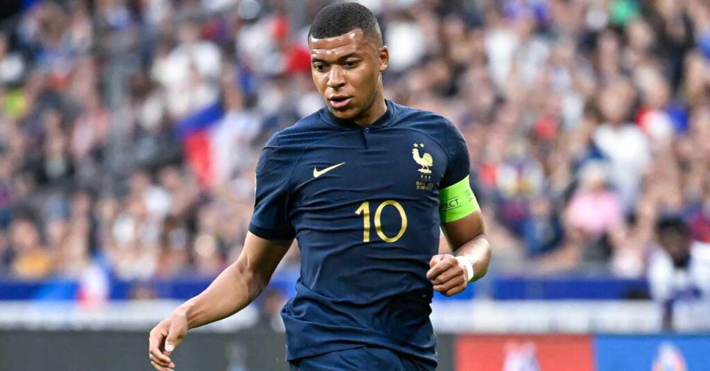 La Liga team Real Madrid Football Club footballer Kylian Mbappe playing for the France national team in a blue shirt while wearing a green captain armband on his left arm with his number 10 and the Nike logo in yellow on his chest